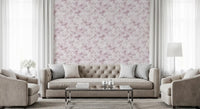 Pink watercolour floral wallpaper in an elegant living room with a grey sofa GD12352