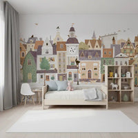 Pastel town mural behind a white toddler bed in a soft nursery GD12398
