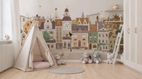 Colourful village mural in a kids room with a blue bed and toy rug GD12398