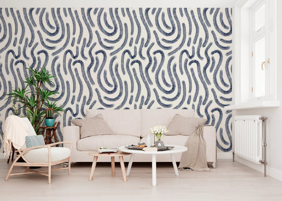 Indigo fluid line wallpaper in a bright living room with cream sofa GD12465