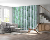 Green watercolour stripe wallpaper in a bright living room with grey sofa GD12468