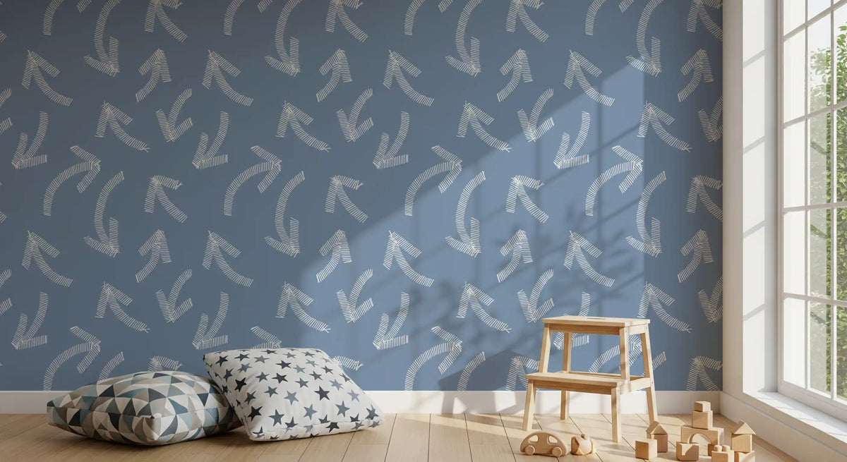 Blue scribble wallpaper in a toddler room with star cushions and toys GD12470