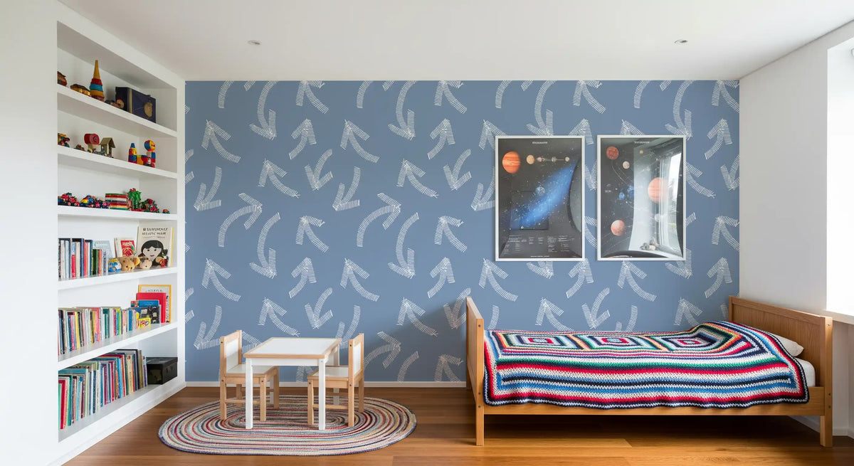 Muted blue arrow wallpaper in a kids bedroom with books and small bed GD12470