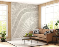 Cream etched mural in a living room with a tan leather sofa and plants GD12473