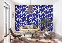 Blue shape wallpaper in a living room with a dark chair and terracotta floor GD12480