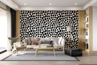Monochrome ink blot wallpaper in a bright living room with cane armchair GD12487