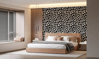 Black spot wallpaper behind a wooden sideboard with plants GD12487