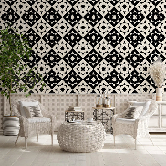 Black and white geometric tile wallpaper in a lounge with rattan chairs GD12503
