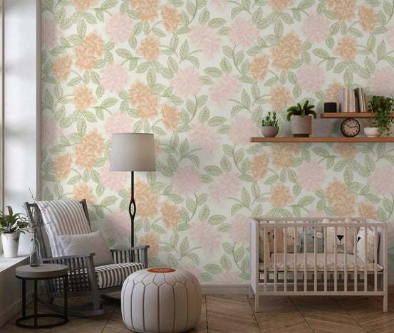 Nursery corner in peach peony floral wallpaper with a cot and soft neutral decor GD12643