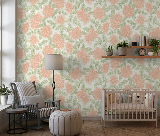 Nursery corner in peach and sage botanical wallpaper with a cot and neutral decor GD12646