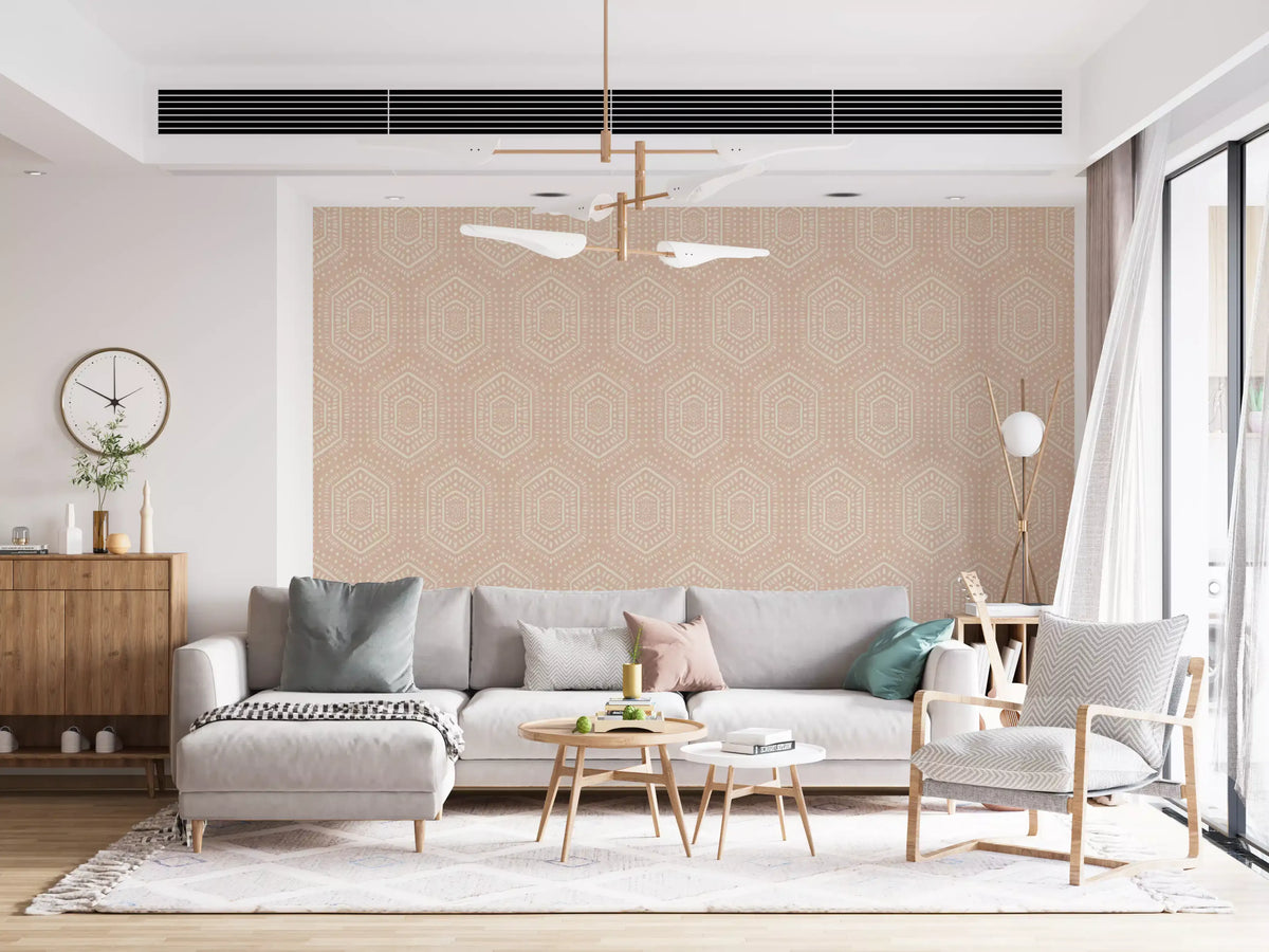 Blush boho hexagon wallpaper in a bright living room with a grey sofa GD12655