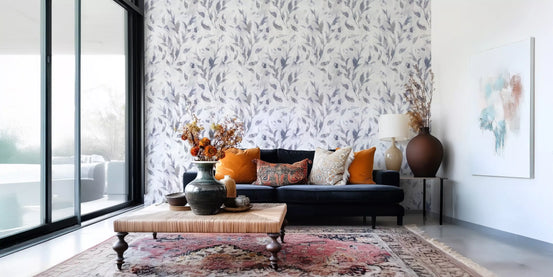 Willow leaf botanical wallpaper in a living room with a dark sofa and terracotta rug GD12681