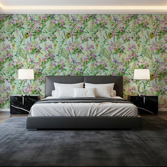 Pink and green floral garden wallpaper on a bedroom wall behind a black bed GD12693