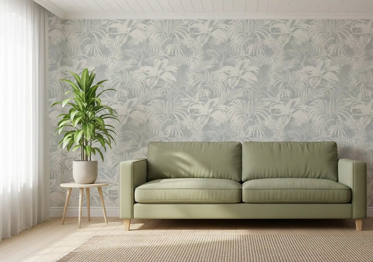 Grey palm leaf wallpaper behind a green sofa in a living room GD12704