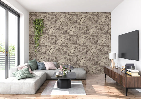 Wildlife meadow toile wallpaper on a living room feature wall behind a grey sectional sofa GD12742