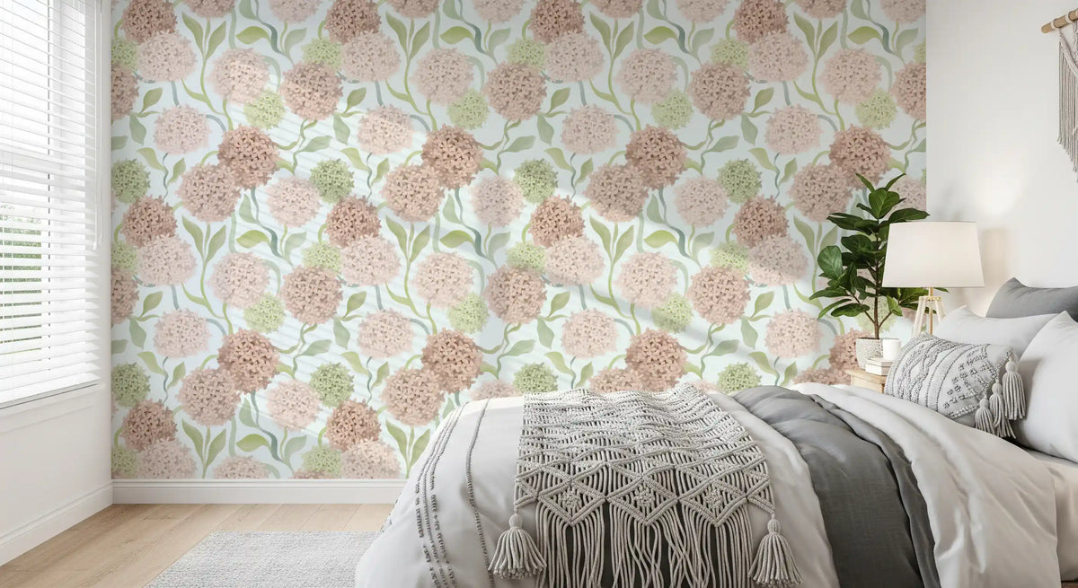 Pink and green floral watercolour wallpaper in a cosy bedroom with a grey bed GD12712