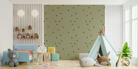 Kids bedroom wallpaper showing earthy sage green with sparse olive dot. accents