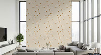 Scattered square dot pattern in caramel brown on a soft beige wallpaper.