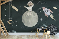 Space adventure mural with puppy and rocket