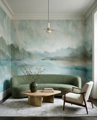 Painterly wall mural featuring faded sage green tree forms and teal water., GD10394