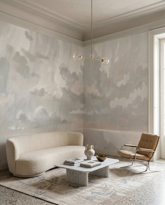 Muted neutral cloud wall mural with mirrored reflections in a hallway.