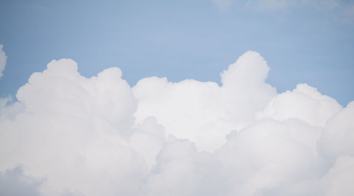Blue Sky and Fluffy White Cloud Wallpaper in your room — zoomed