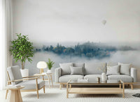 A beautiful panoramic vista wallpaper mural of mountain peaks rising above the mist.
