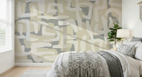 Neutral palette Abstract Terrain wallpaper behind a velvet sofa.