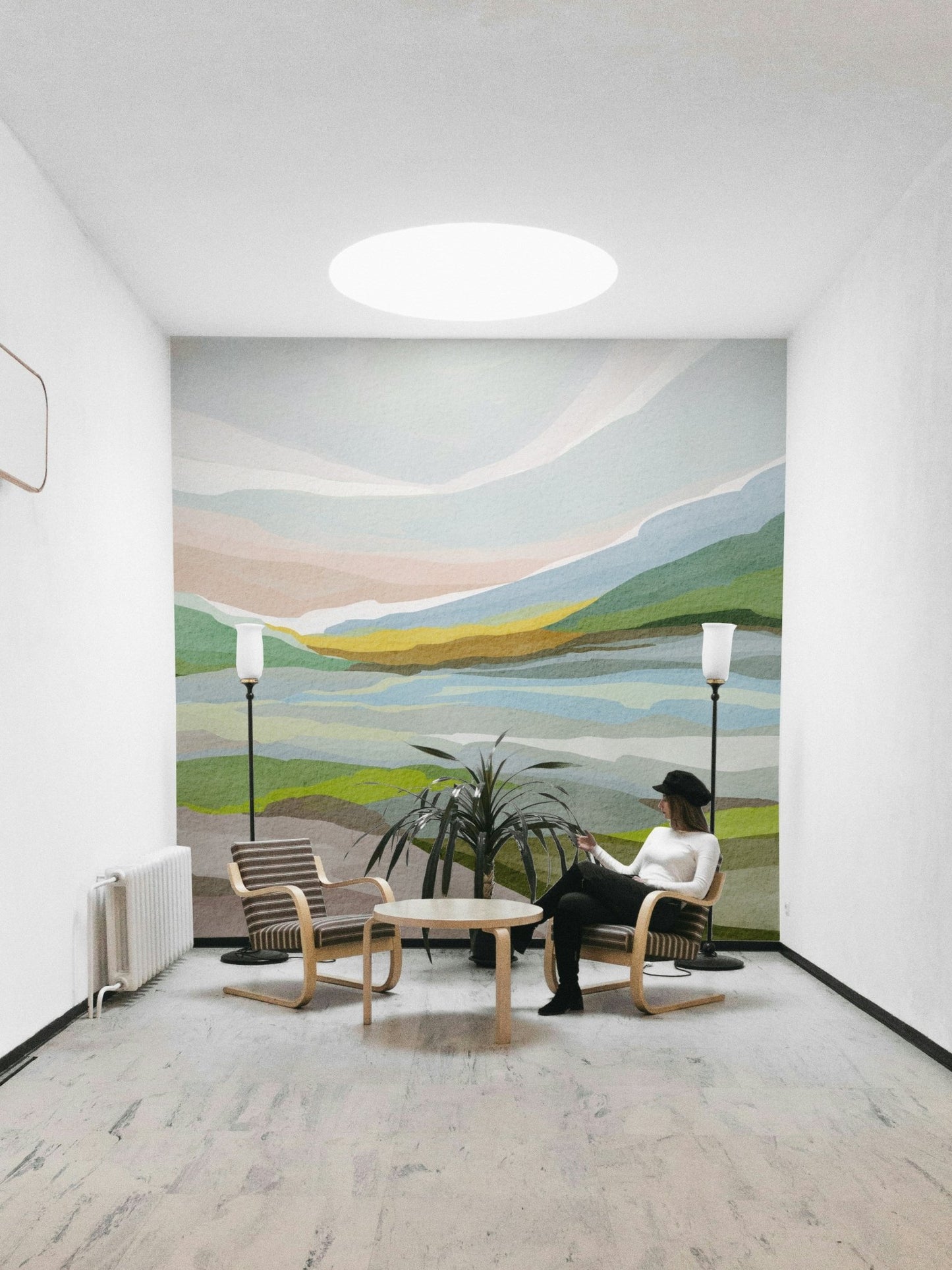 Tranquil interior with watercolor hill mural

