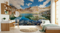 In this bedroom, Alpine Azure Wall Mural opens the wall with peaks and mirrored water