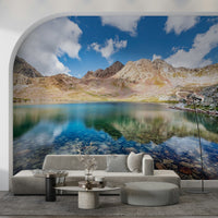 Framed within an arched wall, Alpine Azure Wall Mural gives this lounge a scenic feature