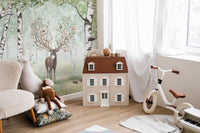 Stag with floral antlers surrounded by woodland creatures.