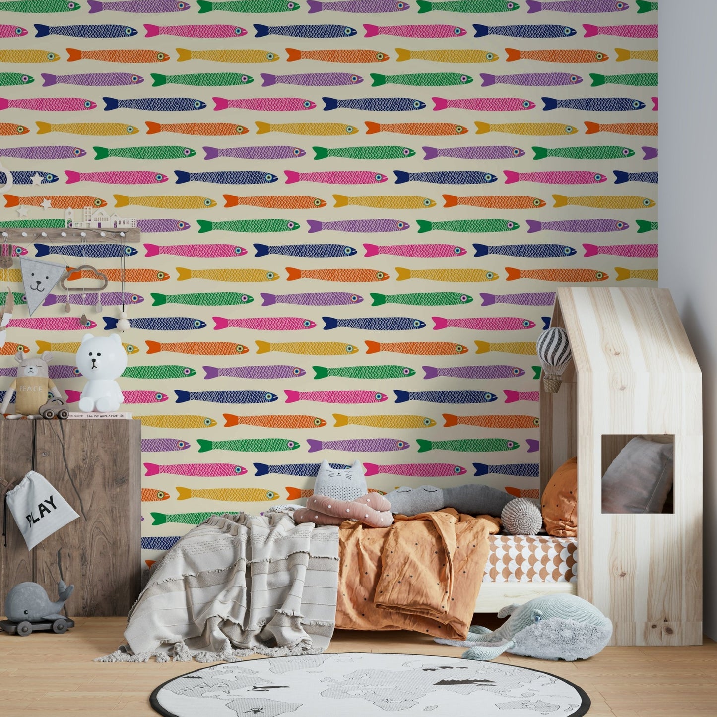 Anchovies fish in rainbow shades on a cream wallpaper backdrop

