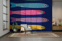 Anchovies with rainbow colors on blue wall.

