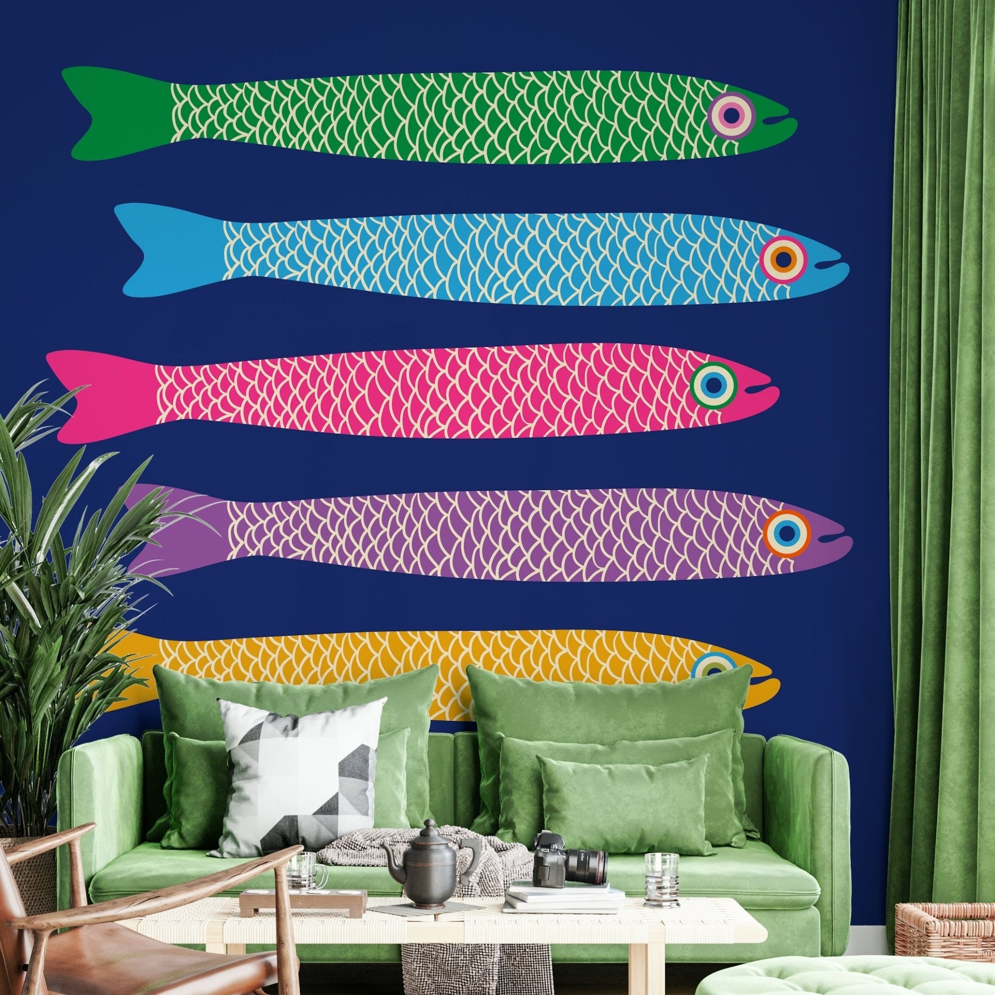 Rainbow anchovies swimming on blue wall.

