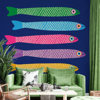 Rainbow anchovies swimming on blue wall.


