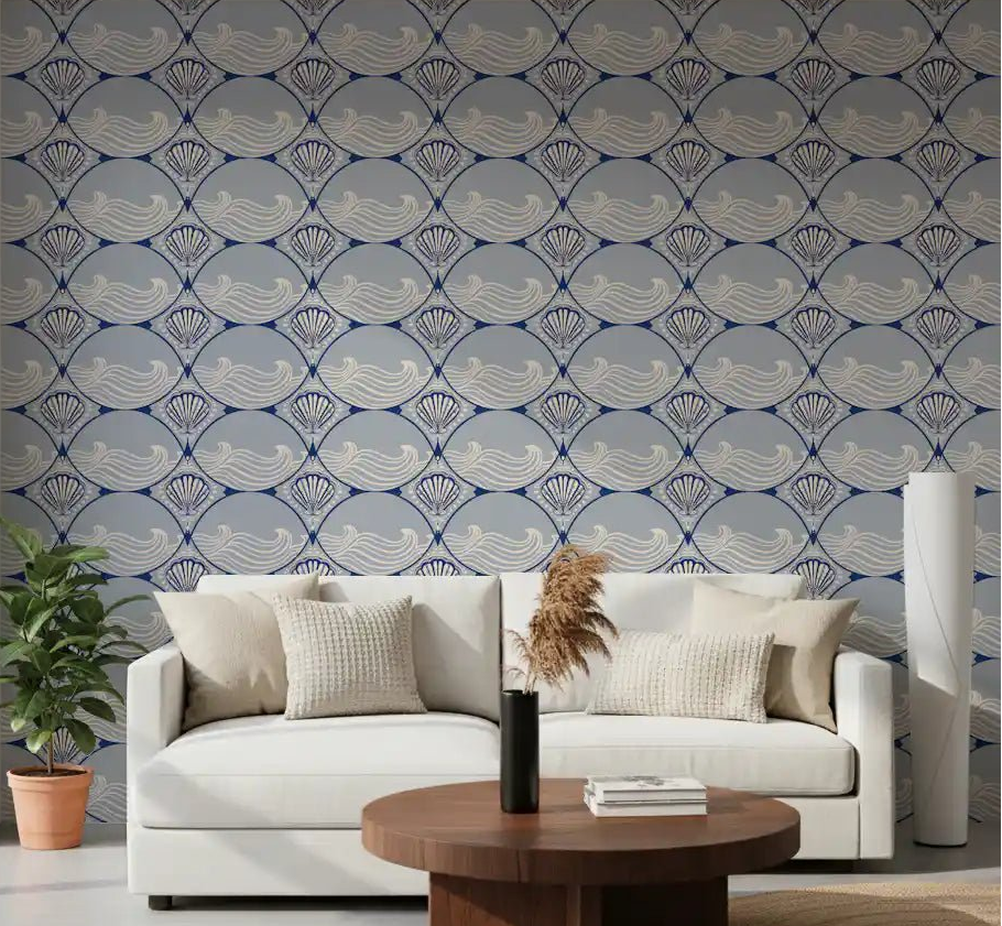 A modern living room wall features the repeating Art Deco Ocean Shells Wallpaper pattern.