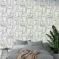 An angled shot of a wall with an artistic face wallpaper

