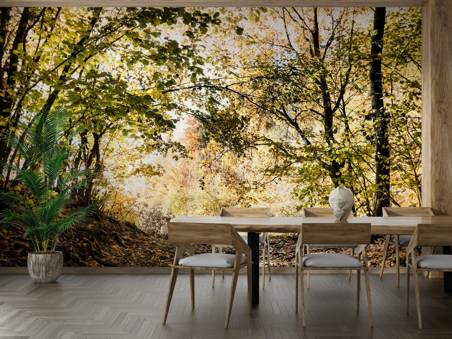 The ground is covered with vibrant golden, yellow, and orange fallen leaves.
