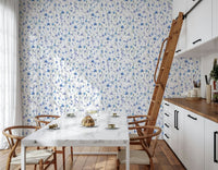 Azure Bloom Garden Wallpaper as a backdrop for a guest bedroom with white linens.