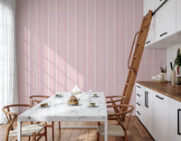 Open dining interior balanced with clean stripe wallpaper in soft blush