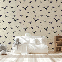 A bedroom decorated with a bat mural


