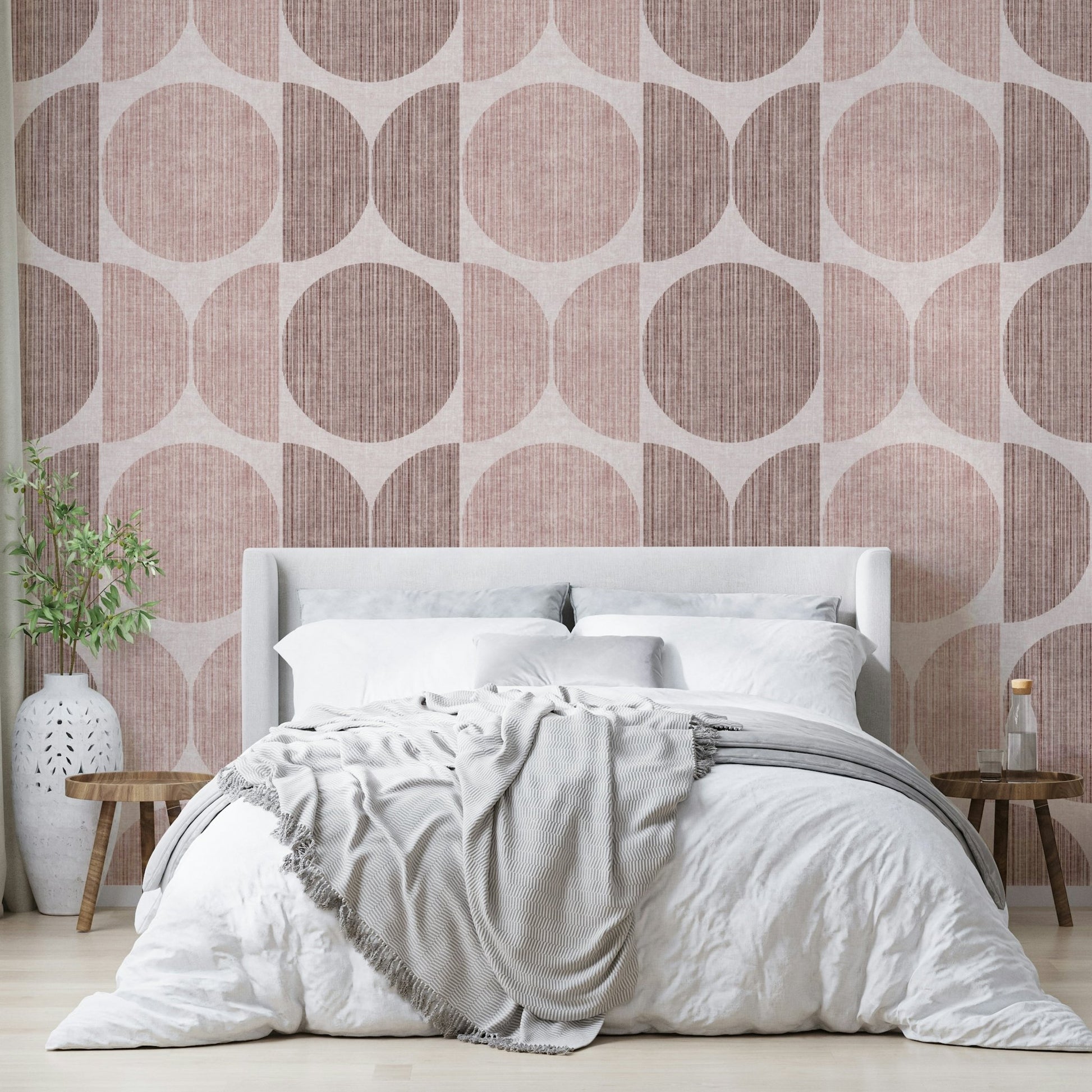 A graceful subtle circle wall mural in warm, pink tones.

