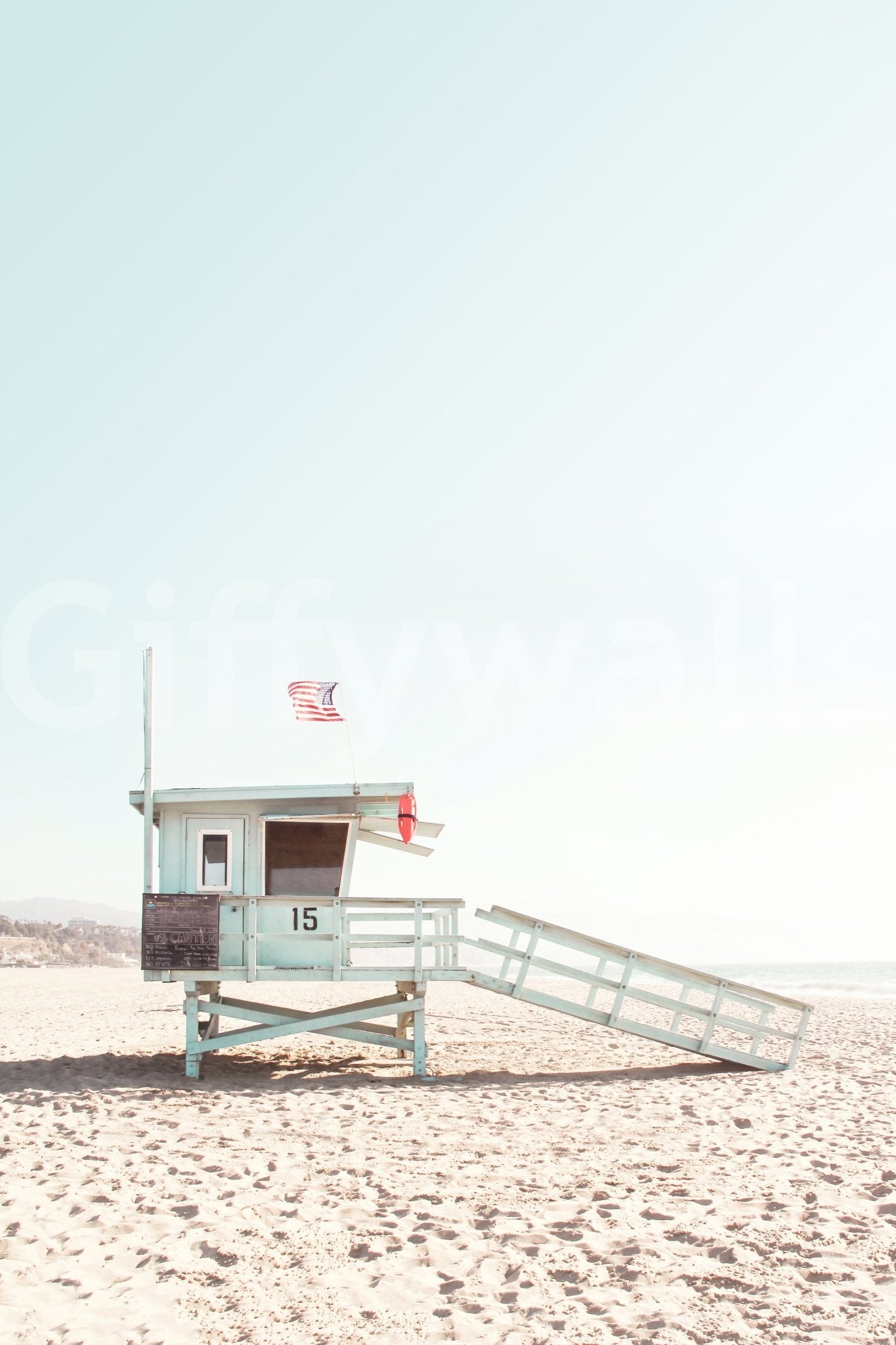 Blue skies, golden sand, and calm waves.