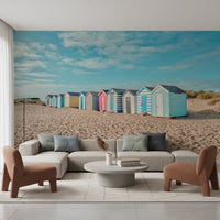 A warm lounge styled with Beach Huts on the Shore Wall Mural and pastel beach huts, GD8871