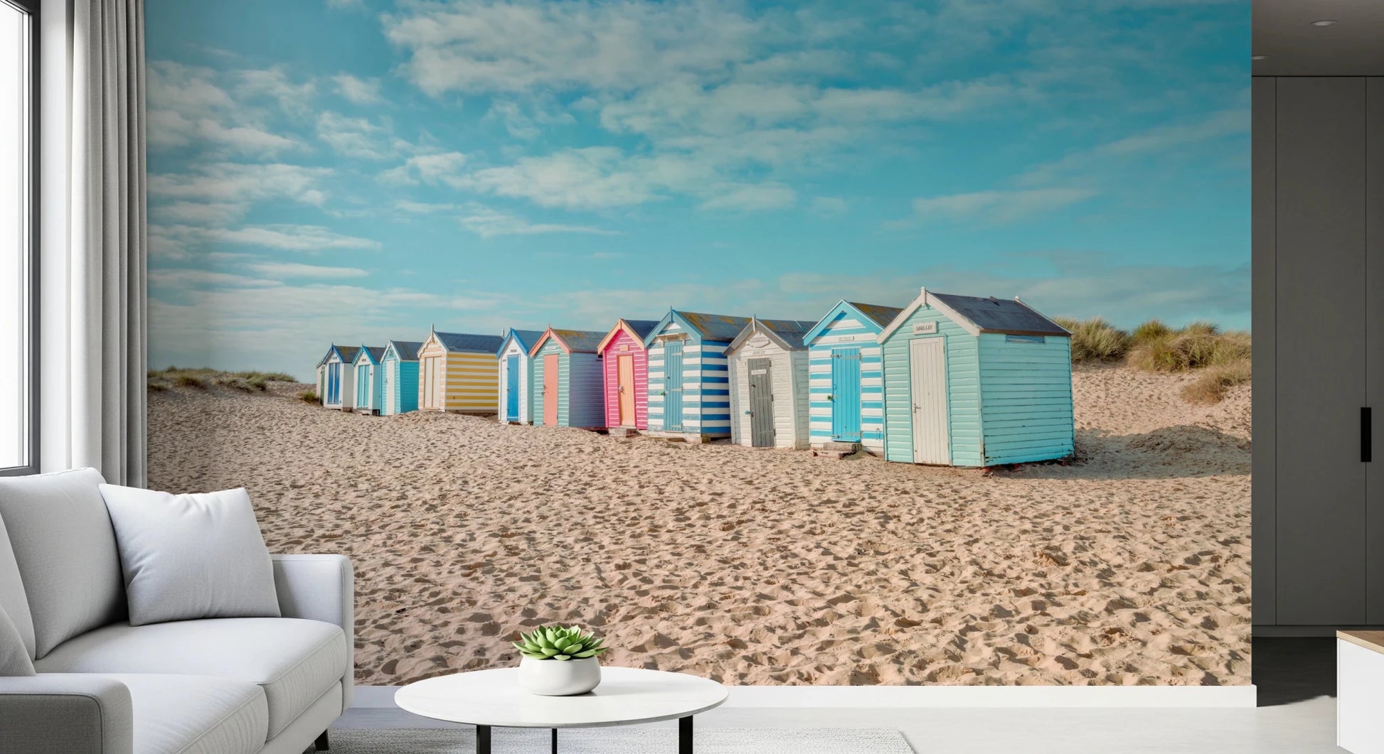 Beach Huts on the Shore Wall Mural styled in a relaxed lounge with soft neutral seating, GD8871