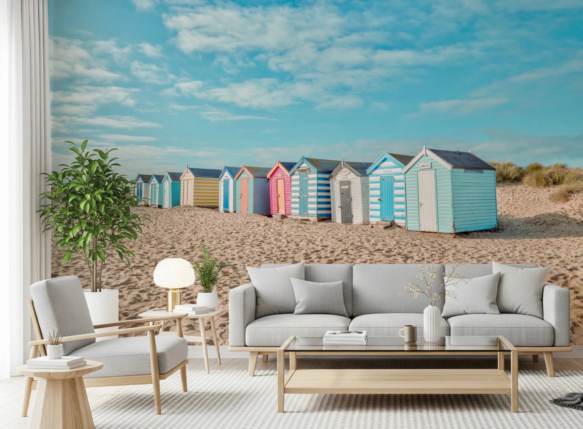 This airy sofa setting features Beach Huts on the Shore Wall Mural and open sky tones, GD8871