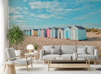 This airy sofa setting features Beach Huts on the Shore Wall Mural and open sky tones, GD8871