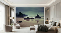 Wall mural Bedruthan Steps Beach rugged rocks and smooth water surface.