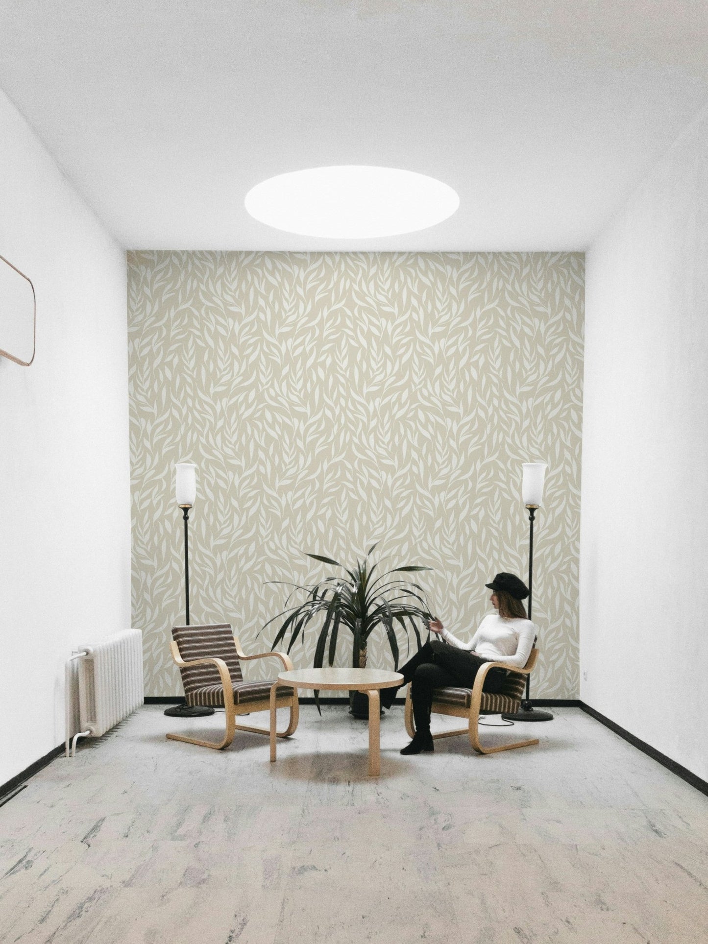 A bedroom decorated with a foliage mural

